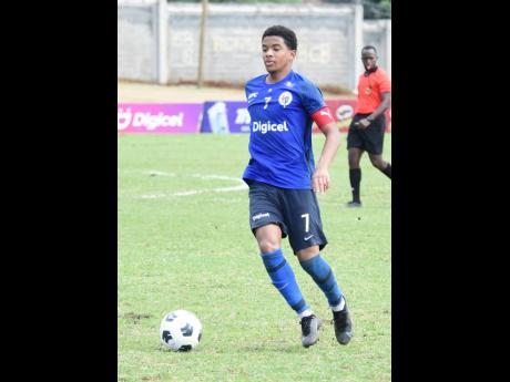 Duncan McKenzie, Jamaica College’s Manning Cup captain, dribbles the ball during yesterday’s ISSA-Digicel Manning Cup semi-final match against Charlie Smith High at the Stadium East field.