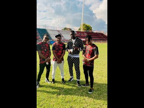 Credit: Contributed Shelly Belly (left), and (from second left) Boom Boom, TugStar and Sparta Unstoppable take a break from dancing during the ‘Knock E Ball’ video shoot at the Anthony Spaulding Sports Complex in St Andrew, the home of Arnett Gardens Football Club.