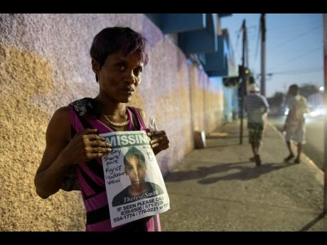 Marrisa Reid holds a poster showing her daughter, Theresa Smith, who has been missing since Monday, March 23, 2020. 