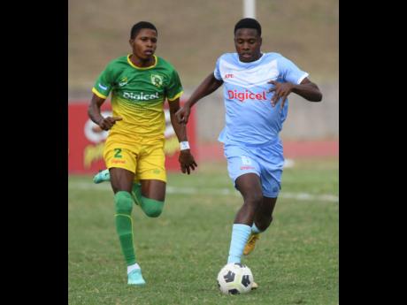 Excelsior High School’s Tyrieke Spaulding (left) pursues St Catherine High School’s Kyle McGleggan during their ISSA Walker Cup semi-final match at Stadium East in Kingston on Friday, January 14, 2022.