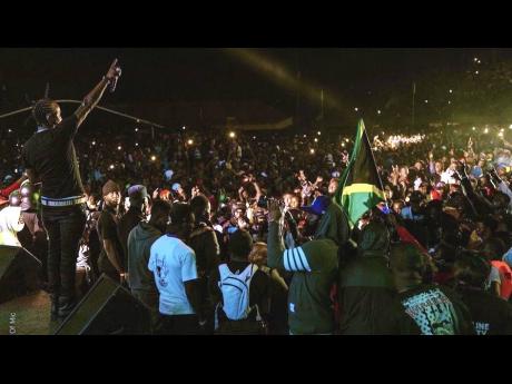 Popcaan salutes the crowd during his performance.