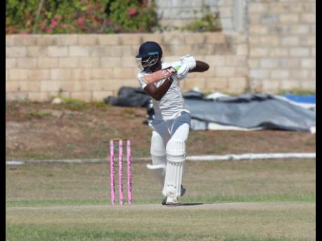 Pete Salmon drives through the offside on his way to scoring 66 for the John Campbell’s XI in the third  Jamaica Cricket Association trial match at Kensington Park.