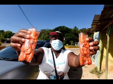 Credit: Kenyon Hemans Omego Johnson, a shrimp vendor from the community of Middle Quarters, which is dubbed the shrimp capital of Jamaica.