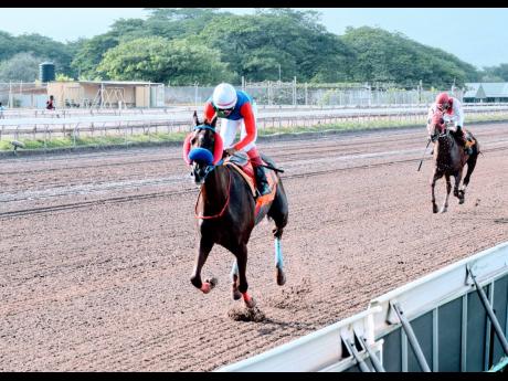 Double Crown, (left), ridden by Anthony Thomas, wins the seventh race over eight furlongs at Caymanas Park in St Catherine on Saturday, July 31, 2021.