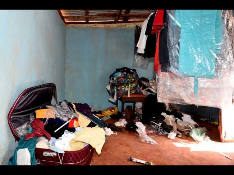 Clothes litter a room of the house in which John Joel Joseph was arrested by local cops last Saturday in Warminster, St Elizabeth.