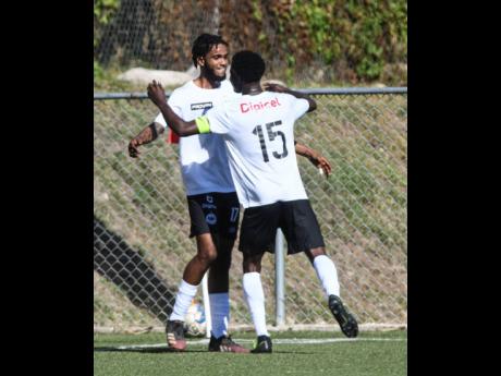 Cavalier’s Shaniel Thomas (left) celebrates his goal against Arnett Gardens with teammate Kyle Ming.