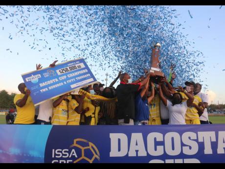 Garvey Maceo celebrate after beating their opponents Manning’s School at the ISSA/WATA daCosta Cup final at the STETHS Sports Complex on Friday.