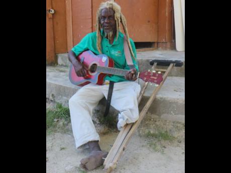 Credit: Ashley Anguin Herman Gordon, also known as ‘Busta One Foot’, performs a song at the The Boat Bar & Cottages in Negril, Westmoreland, last Friday.
