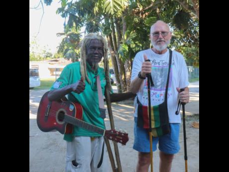 Credit: Ashley Anguin Busta One Foot shares a moment with his long-time friend, Mark Sullivan, a tourist from Boston, Massachusetts.