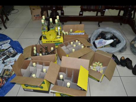 Counterfeit products including rum and shoes that were seized by cops.