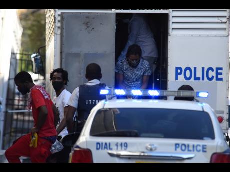 Alleged members of the One Don Gang arrive for another day of testimony at the Home Circuit Court last month.
