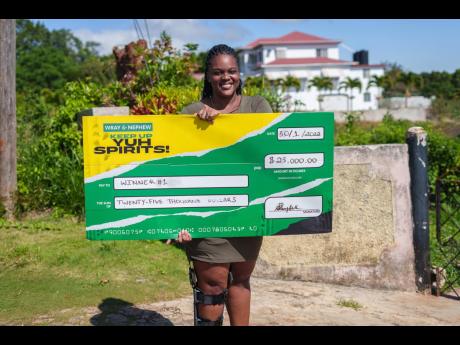 Khadejah Smith beams with joy after receiving a decoy cheque before being later surprised with her actual prize of a new knee brace courtesy of the Wray and Nephew’s ‘Keep Up Yuh Spirits’ campaign.