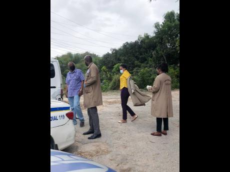 Crime-scene investigators in Tavern Gully, Lawrence Tavern, where Rastafarian Omar Grey was murdered.