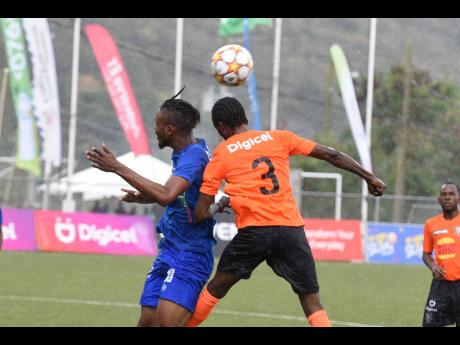 Tivoli Garden’s FC’s Davion Garrison (3) heads the ball away from Dunbeholden FC’s Rushawn Taylor during their Jamaica Premier League match at the UWI-JFF Captain Horace Burrell  Centre of Excellence yesterday. Dunbeholden won 1-0.