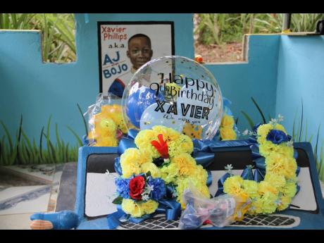 The grave of Xavier ‘AJ’ Phillips, in Red Hills, Clarendon. Xavier was  killed while watching a game of football in Howells Content, York Town, on August 8, 2021. 