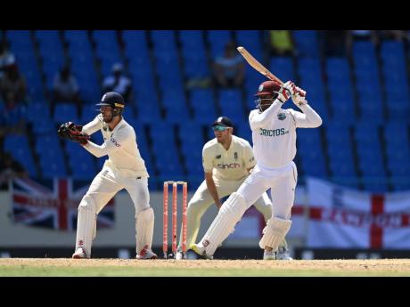 West Indies batsman Nkrumah Bonner (right) plays a shot on his way to his century during their first Test cricket match against England, at the Sir Vivian Richards Stadium in North Sound, Antigua and Barbuda, on Thursday.