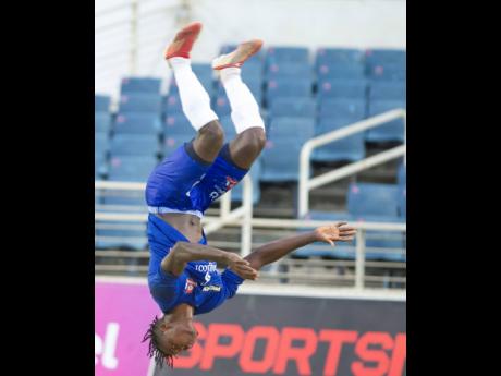 Dunbeholden’s Peter McGregor celebrates one of his goals against Portmore United with a backflip during their Jamaica Premier League match at Sabina Park in Kingston, yesterday.