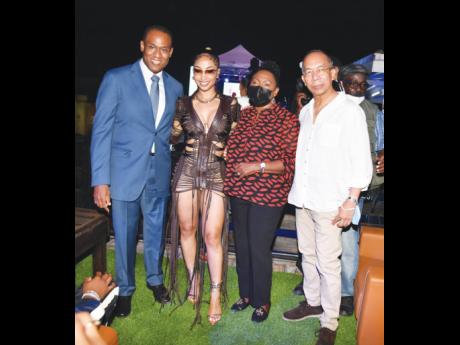 The star power of Shenseea (second left) pulled members of the Government to the launch party for her debut album, Alpha, last night. Here she is pictured with Dr Nigel Clarke (left), minister of finance and the public service, Olivia ‘Babsy’ Grange, minister o entertainment, and Dr Horace Chang (right), minister of national security. 