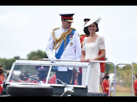 Prince William and Kate, the Duke and Duchess of Cambridge, aboard a Land Rover that was used to transport William’s grandmother, Queen Elizabeth, in 1962. The couple attended a commissioning parade on Thursday at the Jamaican army headquarters.