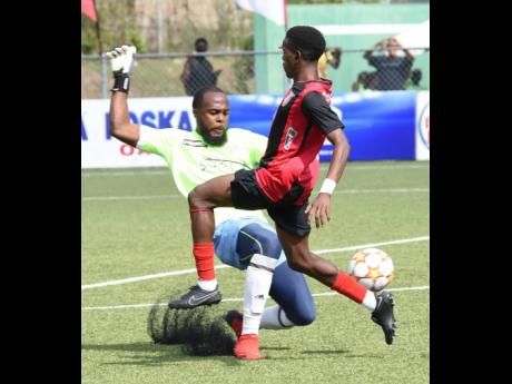Eric Edwards (left), playing here for Portmore United, leaves his line to thwart a goal attempt from Damari Deacon of Arnett Gardens during their Jamaica Premier League football match at the UWI-JFF Captain Horace Burrell Centre of Excellence on Tuesday, January 25.