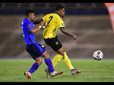 Jamaica’s Leon Bailey (right) makes a pass ahead of El Salvador’s Jairo Henríquez during their Concacaf World Cup qualifier at the National Stadium in Kingston on Thursday night.