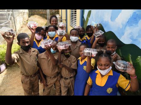 Students of Stony Hill Primary School in St Andrew show off cakes they bought during a fundraiser in support of Abriella Weasley.Students of Stony Hill Primary School in St Andrew show off cakes they bought during a fundraiser in support of Abriella Weasley.