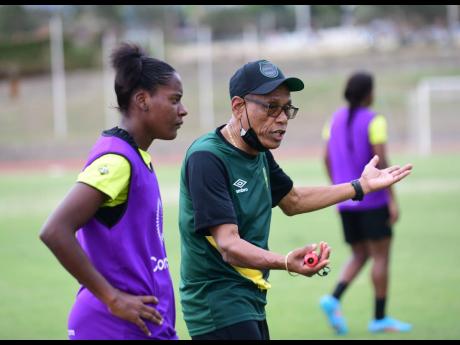 Reggae Girlz head coach Vin Blaine speaks to a player during a training session at Stadium East in St Andrew on Tuesday, February 15.