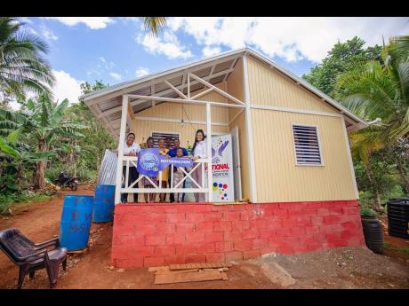 This house was handed over to Desmond Wollaston’s family in Turnberry, Guys Hill, St Catherine, last week. 