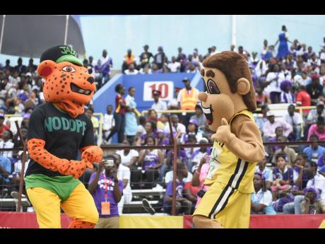Credit: File Jamaica Anti Doping Commission mascot Leo The Dope Patrol Officer (left), and ISSA mascot Champsy at Champs 2018.