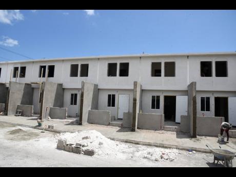 Work continues to transform this old police station into housing units in Olympic Gardens, St Andrew. 