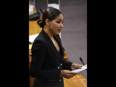 Lisa Hanna, member of parliament for St Ann South East, raises a  motion during the sitting of the House of Representatives on Tuesday for reggae legend Bob Marley to be named a national hero. 