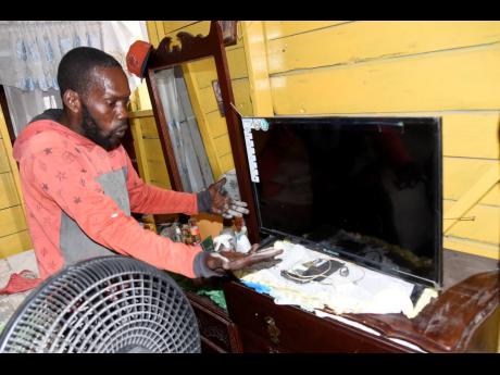 Anthony Hibbert, a resident of Tavares Gardens, says he has to clean his furniture often due to the dust.