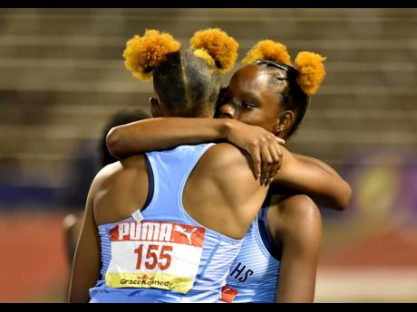 Tina is congratulated by her twin Tia (right), who finished third.