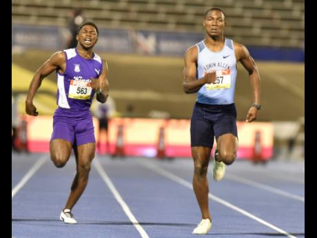 Edwin Allen High’s Bryan Levell (right) wins the Class One 100m in 10.25 seconds during the ISSA/GraceKennedy Boys’ and Girls’ Championships at the National Stadium on Wednesday. At left is Kingston College’s Bouwahjie Nkrumie, who finished sixth in 10.49 seconds.