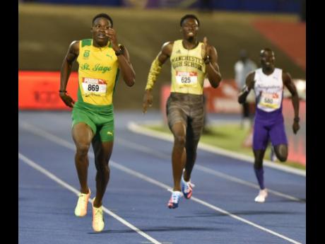 St Jago High School’s Gregory Prince (left) approaches the line to win the Class One Boys 400m title at the ISSA/GraceKennedy Boys and Girls’ Athletics Championships at the National Stadium on Thursday. Also pictured are Manchester High School’s Shemar Palmer (centre) and Kingston College’s Emmanuel Rwotomiya, who were third and sixth respectively.