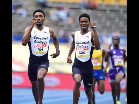 Jamaica College’s middle distance runners Handal Roban (left) and J’Voughnn Blake during the Class One Boys 800m final, which the latter won in record equalling time at the ISSA/GraceKennedy Boys and Girls Athletics’ Championships at the National Stadium on Saturday.