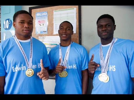 Edwin Allen High School’s Trevor Gunzell (left), Bryan Levell (centre), and Christopher Young pose yesterday on campus with their medals won at the ISSA/GraceKennedy Boys and Girls Championships last week.