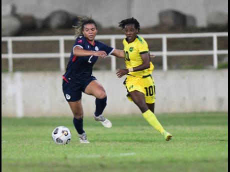 Jamaica’s Jody Brown (right) in action against Dominican Republic’s Giovanna Dionicio during yesterday’s Concacaf Women’s Championships qualifying match at Sabina Park. Jamaica won 5-1.