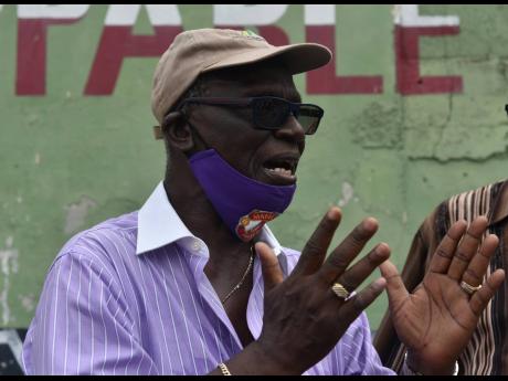Member of Parliament for West Kingston, Desmond McKenzie addresses protestors along Charles Street in Midtown, a section of Tivoli Gardens, during another demonstration about the killing of resident Horaine Glenn.