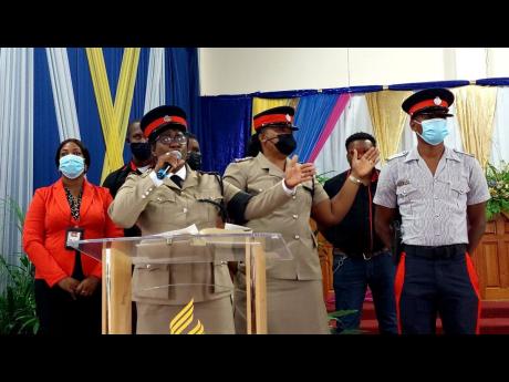 Inspector Tanecia Johnson and personnel from the St Andrew Central Community Safety and Security Branch perform an item at the funeral.