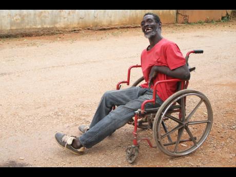 Reid in his old wheelchair last month. He now has a more modern chair to help him get around his community.