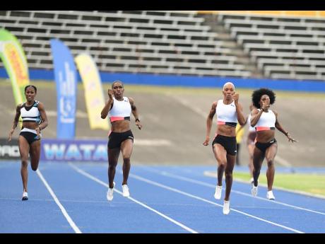 (From left) Ronda Whyte, Janieve Russell, winner Candice McLeod, and Rushell Clayton competing in the Women’s 400m final at Velocity Fest 11 held at the National Stadium on Saturday.