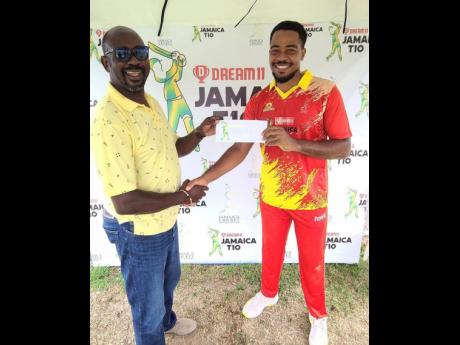 Surrey Risers off-spinner Akim Fraser (right) collects his Man-of-the-Match award from Jamaica Cricket Association (JCA) Second Vice-President Fritz Harrister their win against the Surrey Royals in the Dream11 JCA T10 competition at Sabina Park yesterday.