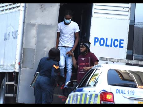 Alleged members of the Clansman-One Don Gang arrived at the Supreme Court in downtown Kingston on Monday.
