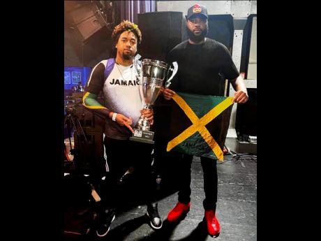 DJ Lank and Chris Dymond show off the coveted silverware after winning the World Clash Sound System competition in Birmingham, England on Sunday.