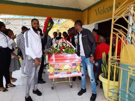 Pallbearers carrying the coffin which bears the remains of Amael Clark at Windsor Road Valley Christian Ministries in Spanish Town, St Catherine, on Saturday.