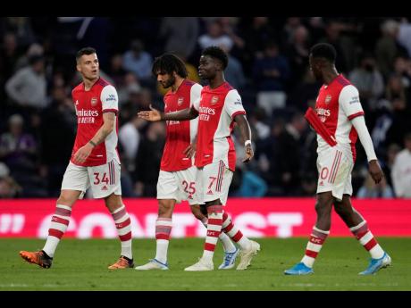 Arsenal players leave the pitch for the halftime during the English Premier League match against north London rivals Tottenham Hotspur at Tottenham Hotspur Stadium in London, England, on Thursday.