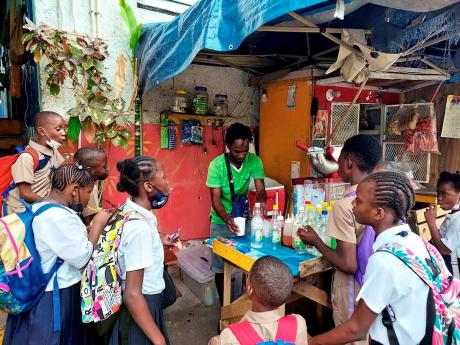 Schoolchildren making their way home stop for a refreshing snow cone at Kevin’s stall on Laws Street. This is a sign that life is returning to some level of normalcy in the area.