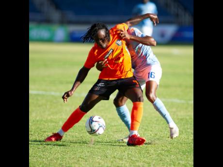 Tivoli’s Rodico Wellington (left) shields the ball from Waterhouse’s Kymani Campbell during a Jamaica Premier League match at Sabina Park on Saturday, March 12.