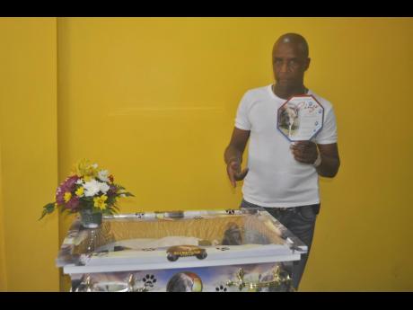 Credit: Rasbert Turner Peter Perry, owner of Perry's Funeral Home, bids goodbye to his pet Ringo.